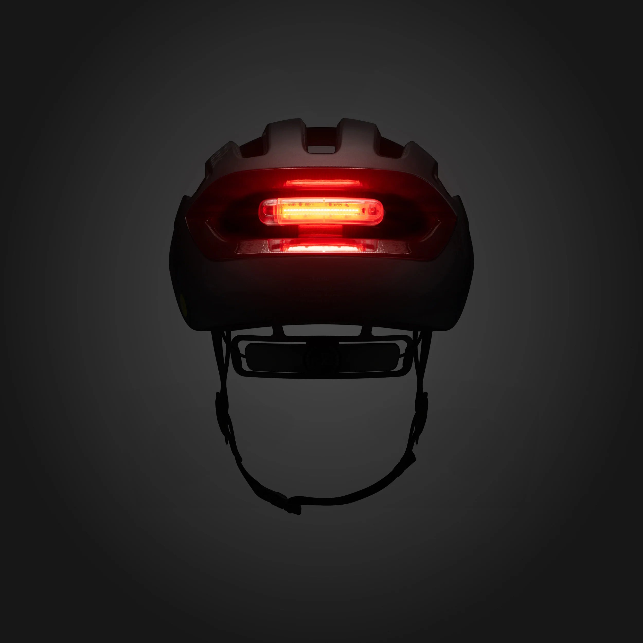 Helmet with a red light on a dark background